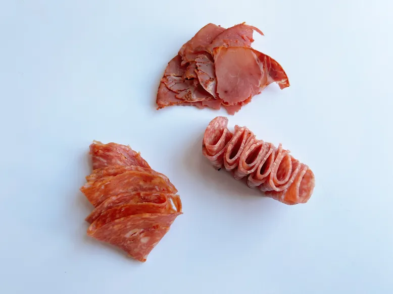 Clockwise from top: Cooked capicola; Genoa salami; soppressata salami.