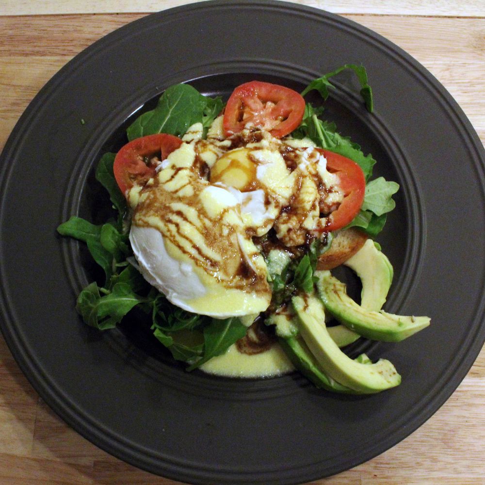 eggs benedict with arugula, avocado, tomato and balsamic glaze