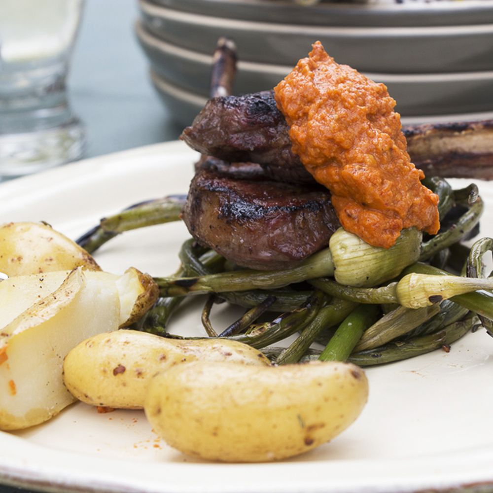 grilled lamb chops & garlic scapes with romesco sauce