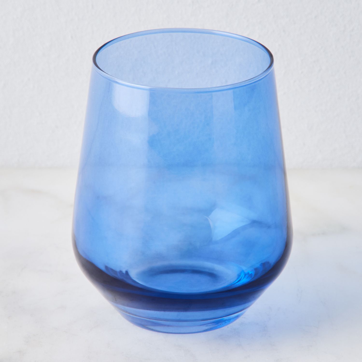 https://images.food52.com/KlUZWgoXxlQFkor8Kef4nHSrZr4=/1500x1500/bf108ca3-6242-4cff-a145-6442d133d6f8--2023-0609_estelle-colored-glass_hand-blown-colored-wine-glasses-set-of-6_cobalt-stemless-wine-glasses_silo_1x1_ty-mecham.jpg