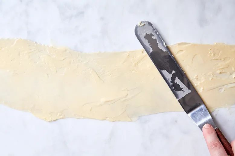 Spread soft butter with an offset spatula.