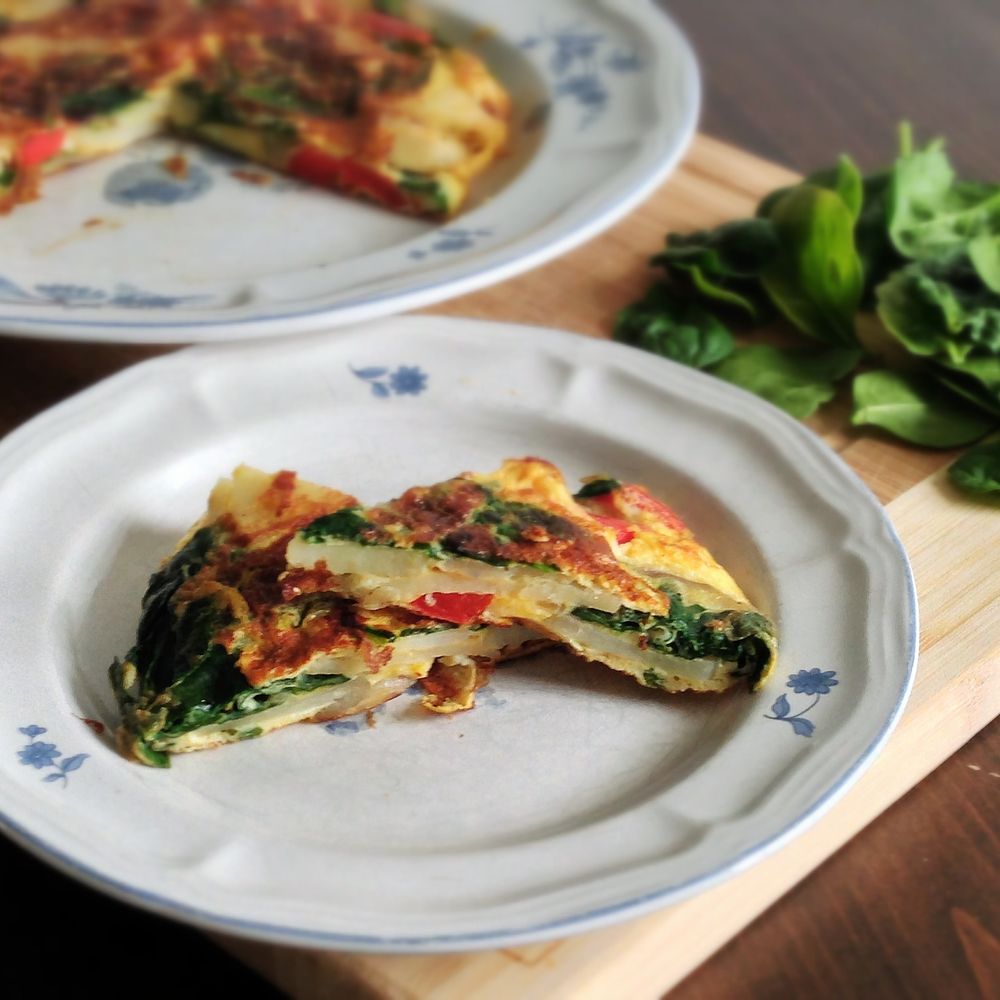 Spanish potato omelet with baby spinach and red pepper