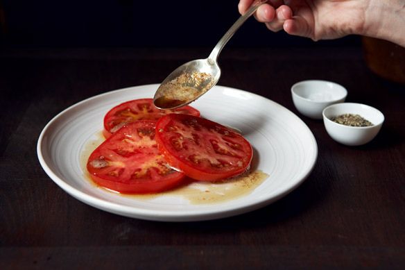 Spooning butter on tomatoes