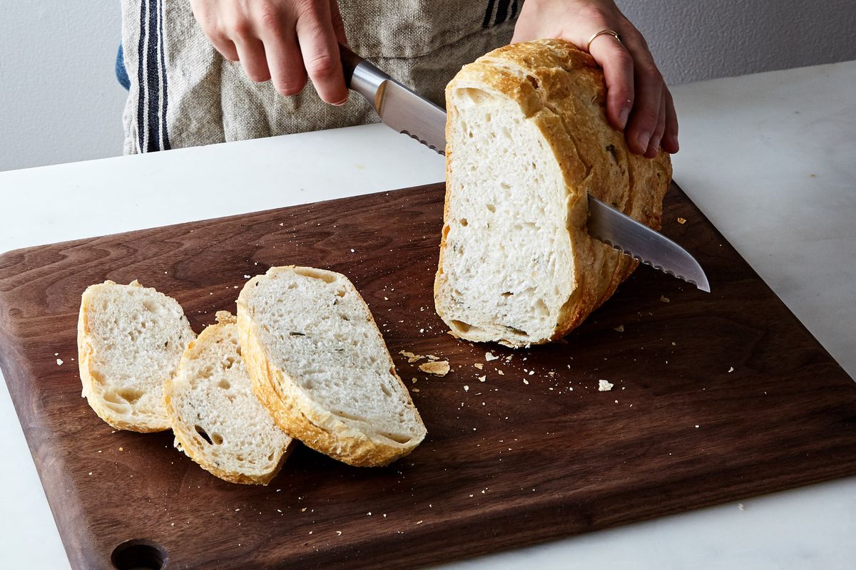 This cutting board has a guide to help you get even slices of bread and  also has a space underneath that catches all the crumbs. No one around here  is impressed! Surely