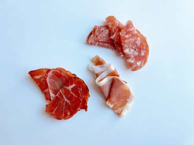 Clockwise from top: Salami di Parma; prosciutto di Parma; spicy coppa.
