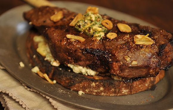 Broiled Spicy Steak with Garlic Chips on Roasted Gorgonzola Crostini